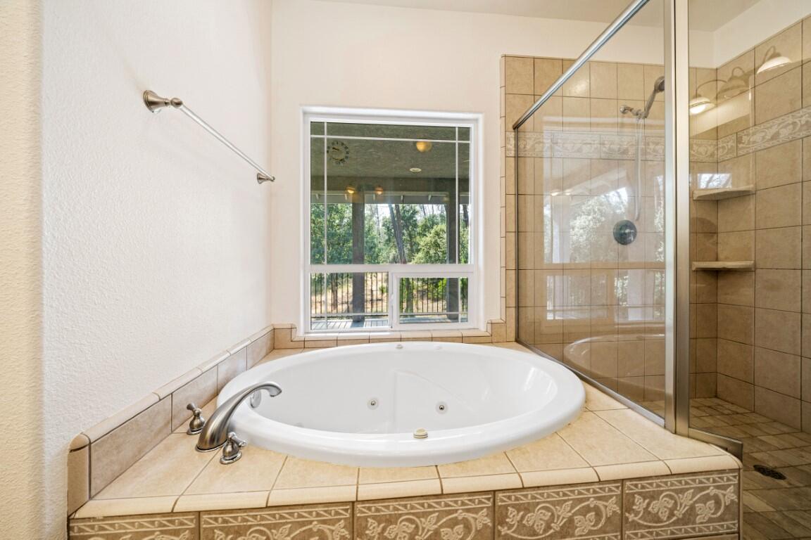 8418 Placer Road Redding, CA 96001 - Photo 8 of 47 a bathroom with a tub and shower