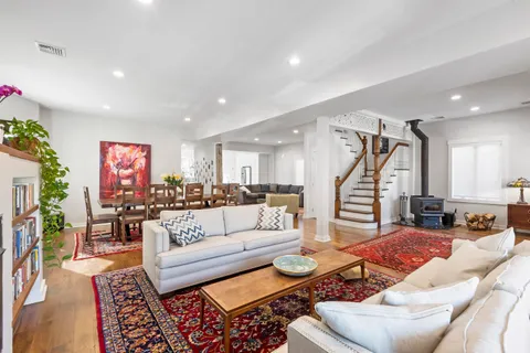 a large kitchen with kitchen island a refrigerator a stove a sink and chairs