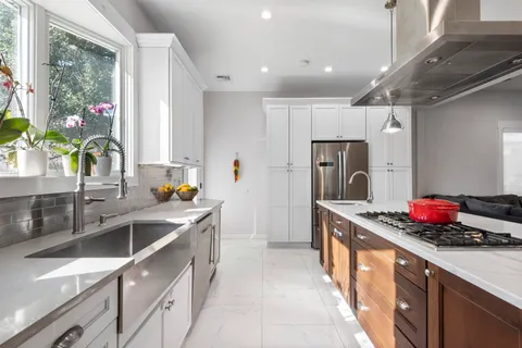 a bathroom with a sink a toilet a mirror and shower