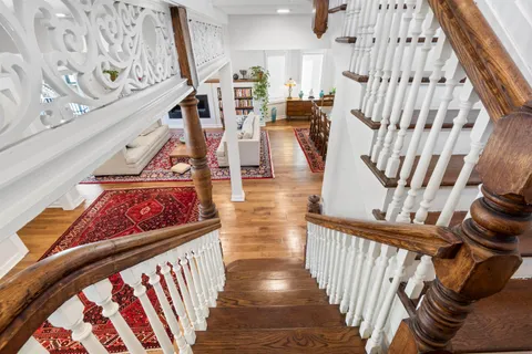 a view of entryway with wooden floor and stairs