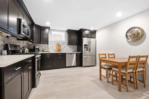a living room with furniture and kitchen view