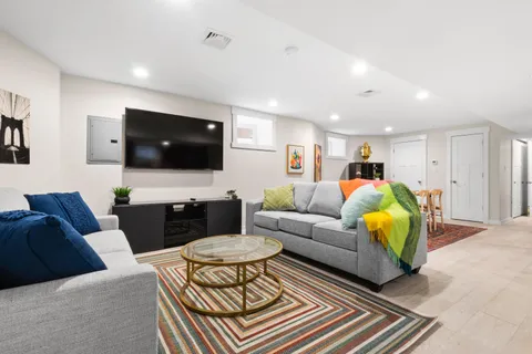 a living room with furniture a flat screen tv and a couch