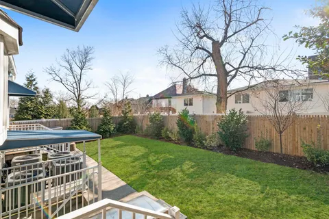 a view of a roof deck with couches and wooden floor