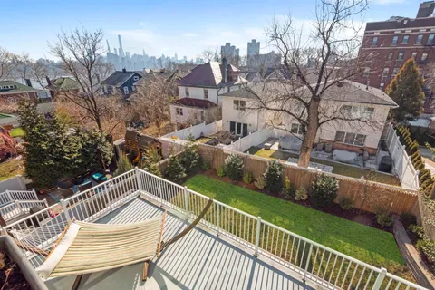 a view of a roof deck with wooden floor and fence