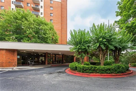 a front view of house with a yard and green space