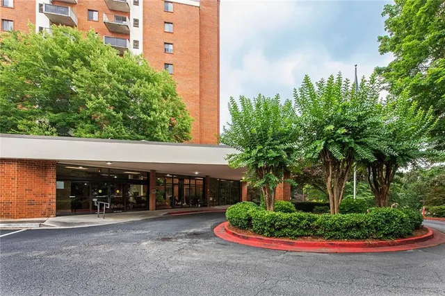 a front view of house with a yard and green space