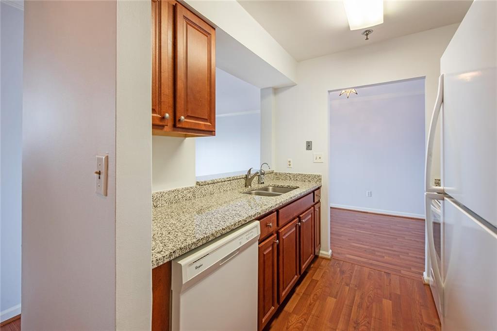 300 Johnson Ferry Road, Unit B808 Atlanta, GA 30328 - Photo 11 of 41 a kitchen with a sink and a wooden floor