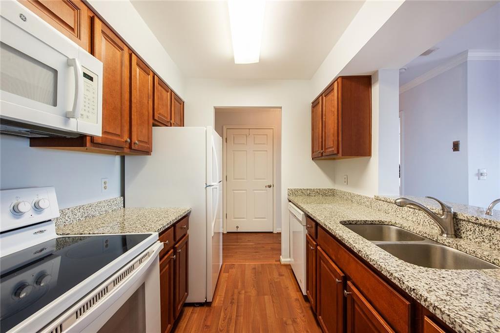 300 Johnson Ferry Road, Unit B808 Atlanta, GA 30328 - Photo 12 of 41 a kitchen with stainless steel appliances granite countertop a sink stove and refrigerator