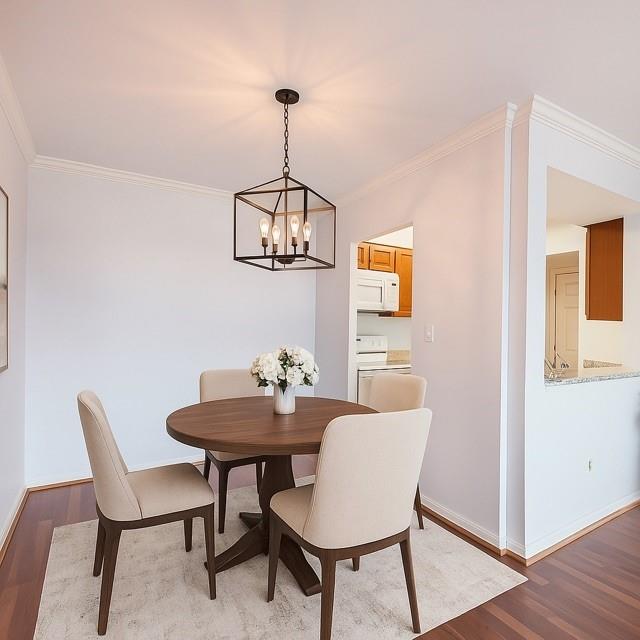 300 Johnson Ferry Road, Unit B808 Atlanta, GA 30328 - Photo 15 of 41 a view of a dining room with furniture wooden floor and a chandelier