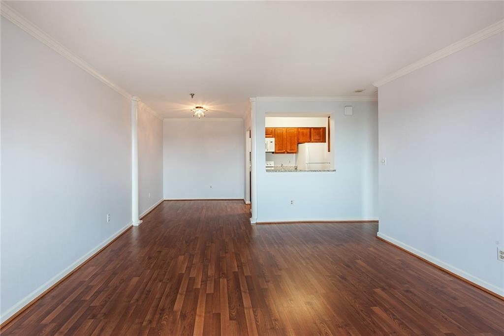 300 Johnson Ferry Road, Unit B808 Atlanta, GA 30328 - Photo 18 of 41 a view of an empty room with wooden floor and a window