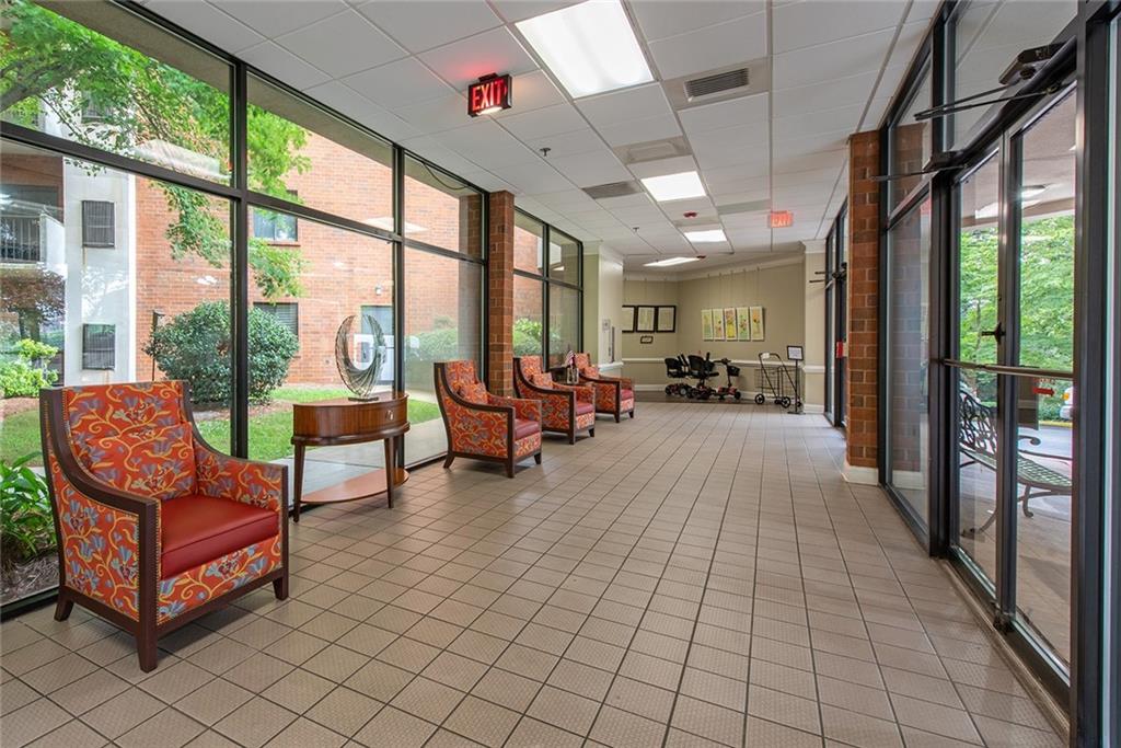300 Johnson Ferry Road, Unit B808 Atlanta, GA 30328 - Photo 2 of 41 a lobby with furniture and floor to ceiling window
