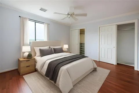 a spacious bedroom with a bed and a window