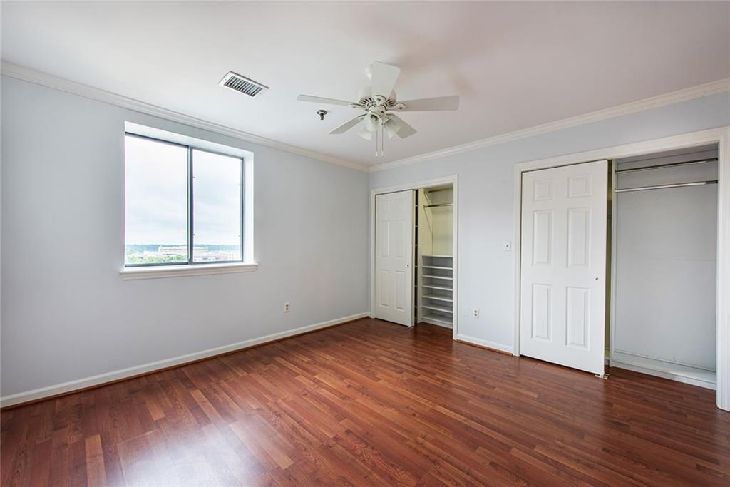 300 Johnson Ferry Road, Unit B808 Atlanta, GA 30328 - Photo 22 of 41 an empty room with wooden floor chandelier fan and windows