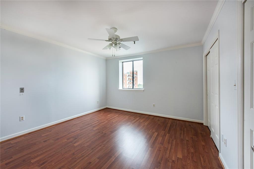300 Johnson Ferry Road, Unit B808 Atlanta, GA 30328 - Photo 24 of 41 a view of an empty room with wooden floor and a window