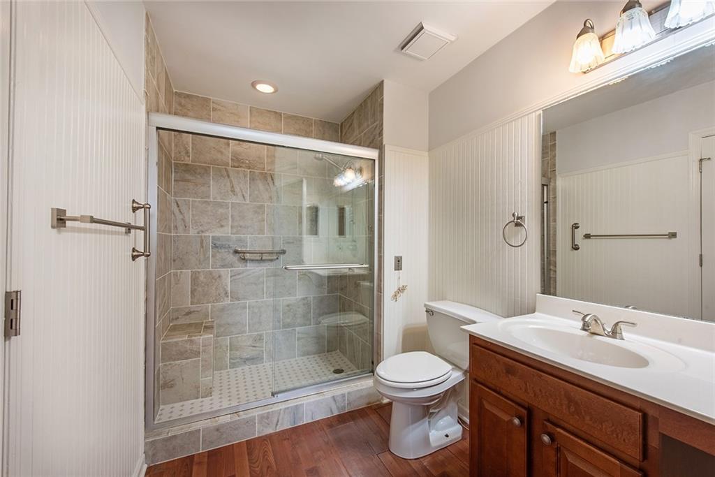300 Johnson Ferry Road, Unit B808 Atlanta, GA 30328 - Photo 26 of 41 a bathroom with a sink toilet a mirror and shower