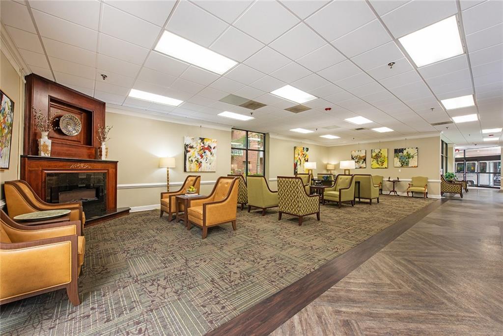 300 Johnson Ferry Road, Unit B808 Atlanta, GA 30328 - Photo 3 of 41 a living room with furniture and a fireplace