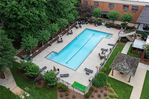 an aerial view of a house with outdoor space and swimming pool