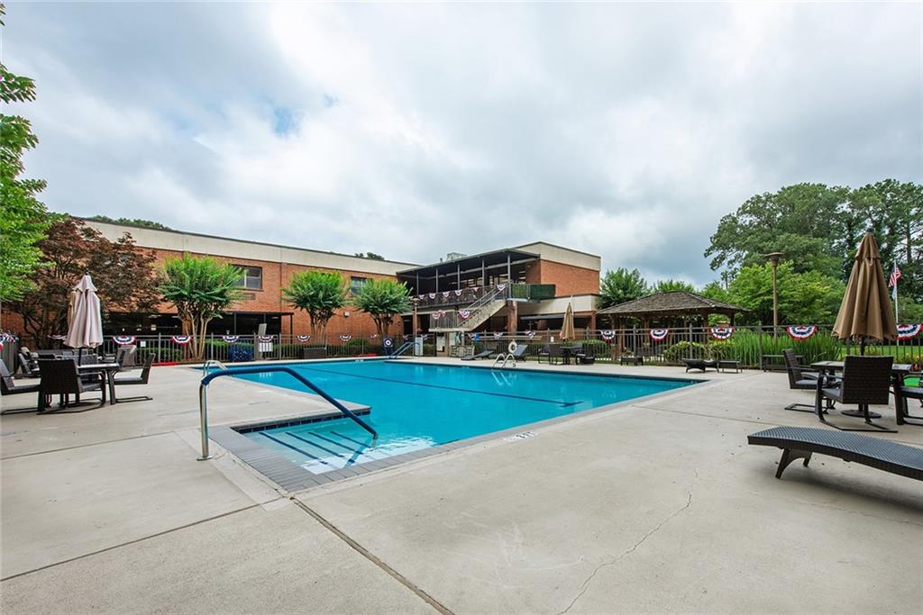 300 Johnson Ferry Road, Unit B808 Atlanta, GA 30328 - Photo 36 of 41 a swimming pool with outdoor seating and barbeque oven
