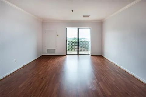 wooden floor in an empty room with a window