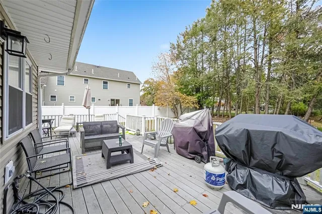 a view of a patio with table and chairs and wooden floor