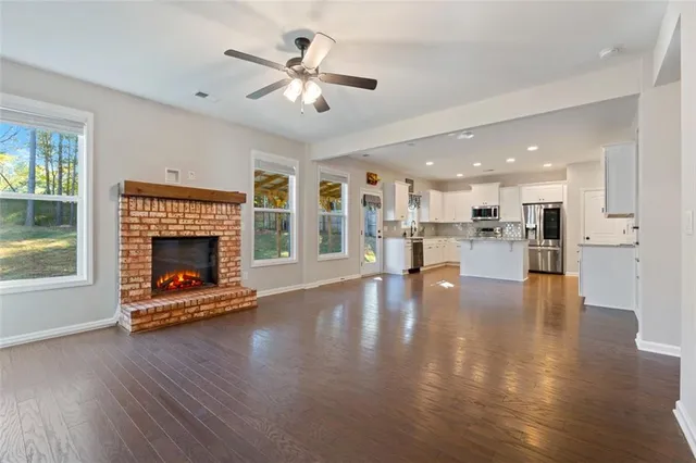 wooden floor in an empty room with a ceiling fan