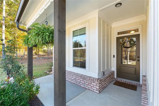 a kitchen with stainless steel appliances a refrigerator a sink a stove a microwave a dining table and chairs