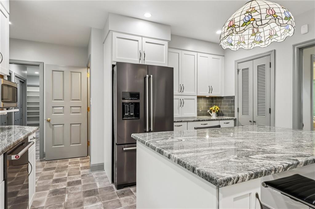 806 Belmont Road Butler, PA 16001 - Photo 20 of 49 a kitchen with stainless steel appliances granite countertop a sink refrigerator and cabinets