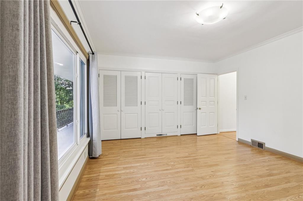 806 Belmont Road Butler, PA 16001 - Photo 31 of 49 a view of an empty room with wooden floor and a window