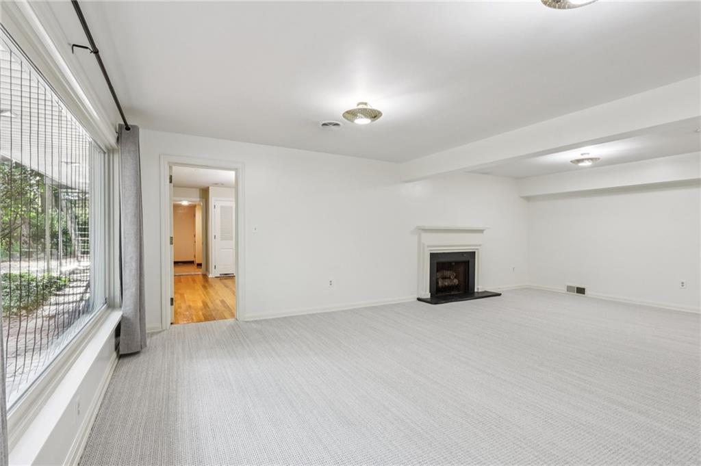 806 Belmont Road Butler, PA 16001 - Photo 32 of 49 an empty room with fireplace and windows