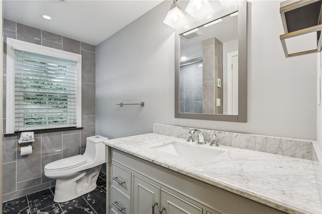 806 Belmont Road Butler, PA 16001 - Photo 34 of 49 a bathroom with a granite countertop sink a toilet and a bathtub