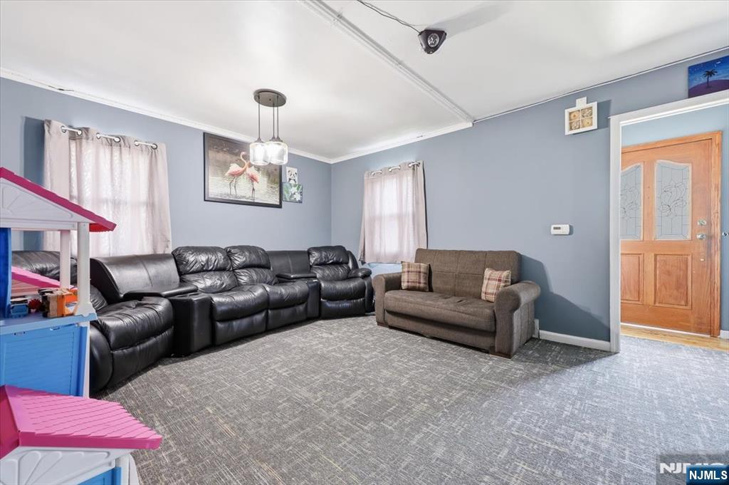 409 Tryon Avenue Englewood, NJ 07631 - Photo 6 of 33 a living room with furniture a fireplace and a window