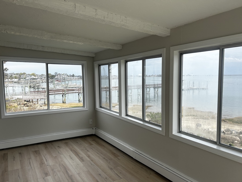 8 Beaver Dam Road, Unit B Scituate, MA 02066 - Photo 4 of 14 a view of an empty room with a window and wooden floor