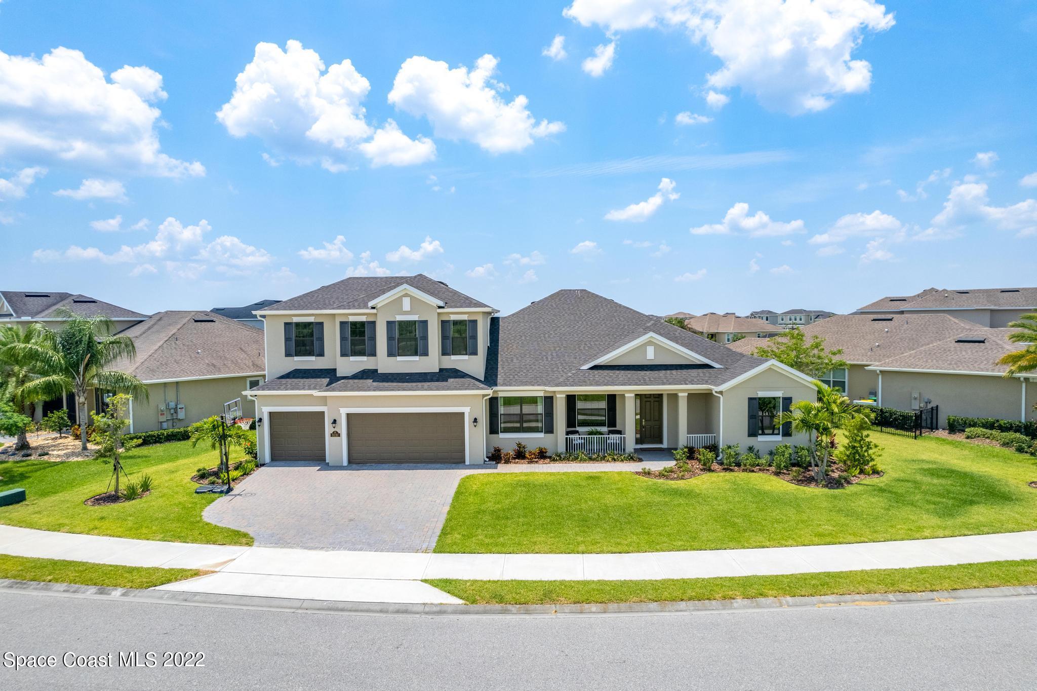 3231 Casterton Drive Melbourne, FL 32940 - Photo 2 of 88 a front view of a house with a yard