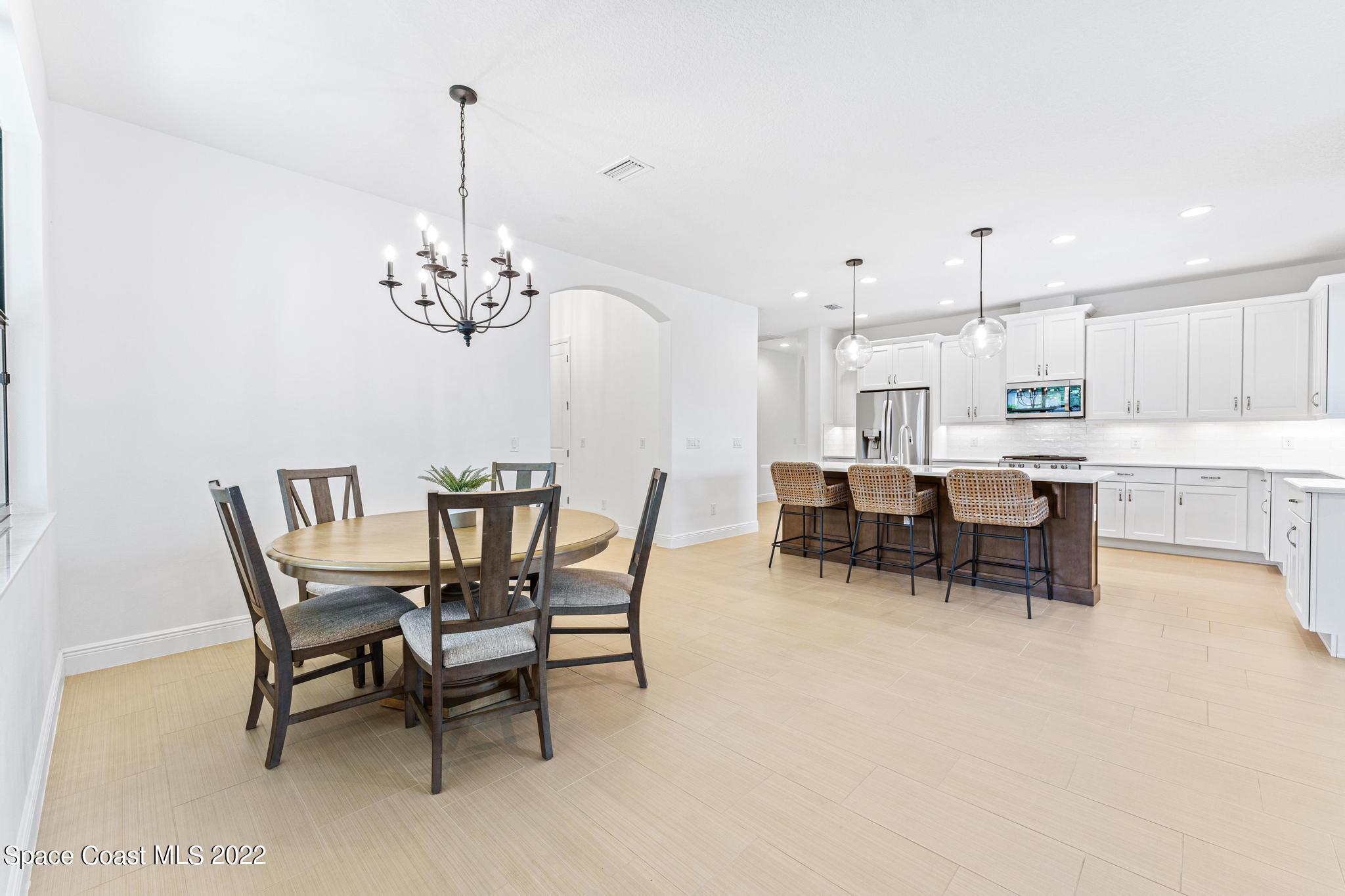 3231 Casterton Drive Melbourne, FL 32940 - Photo 28 of 88 a view of a dining room with furniture and chandelier