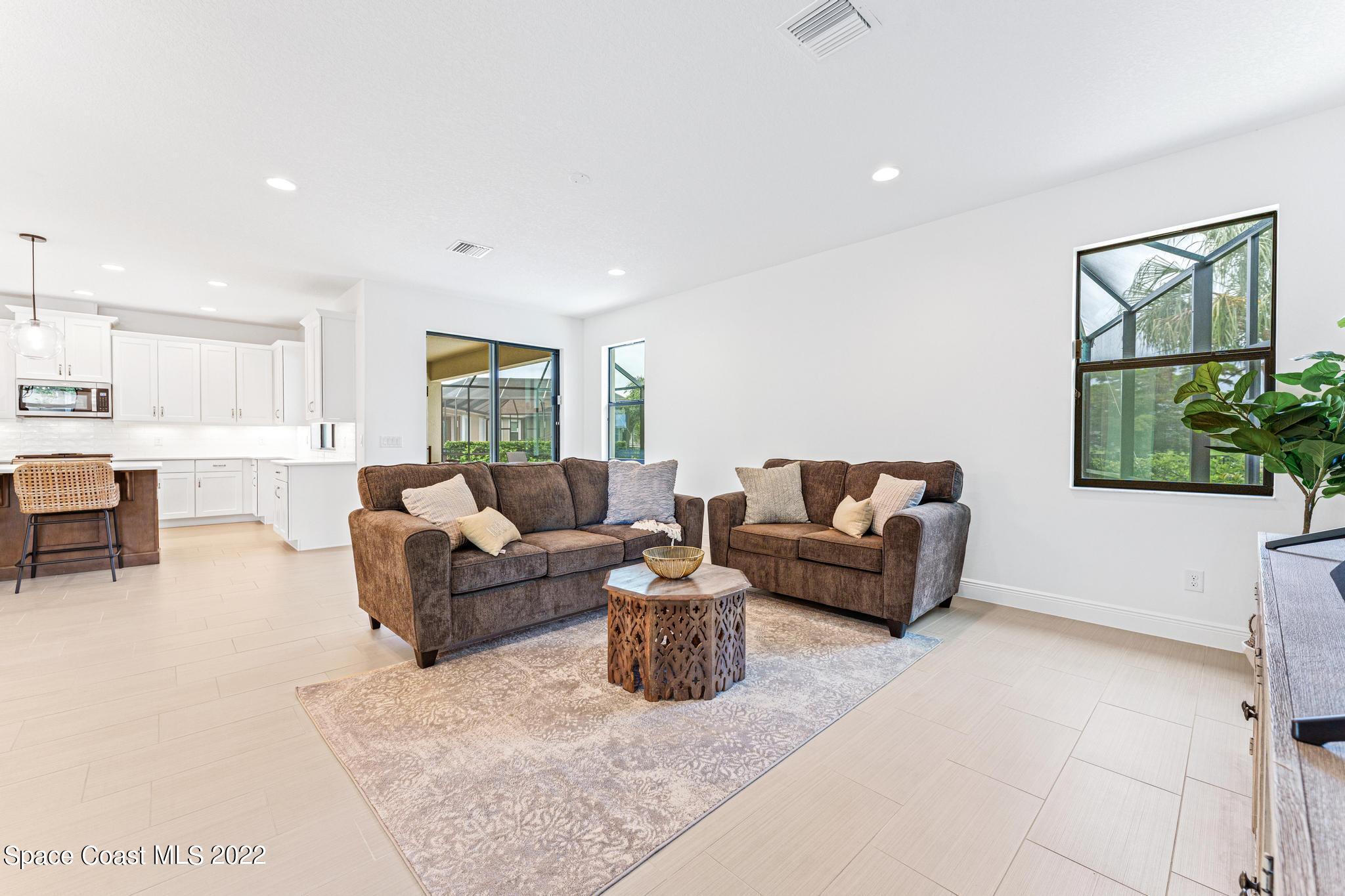 3231 Casterton Drive Melbourne, FL 32940 - Photo 33 of 88 a living room with furniture and a large window