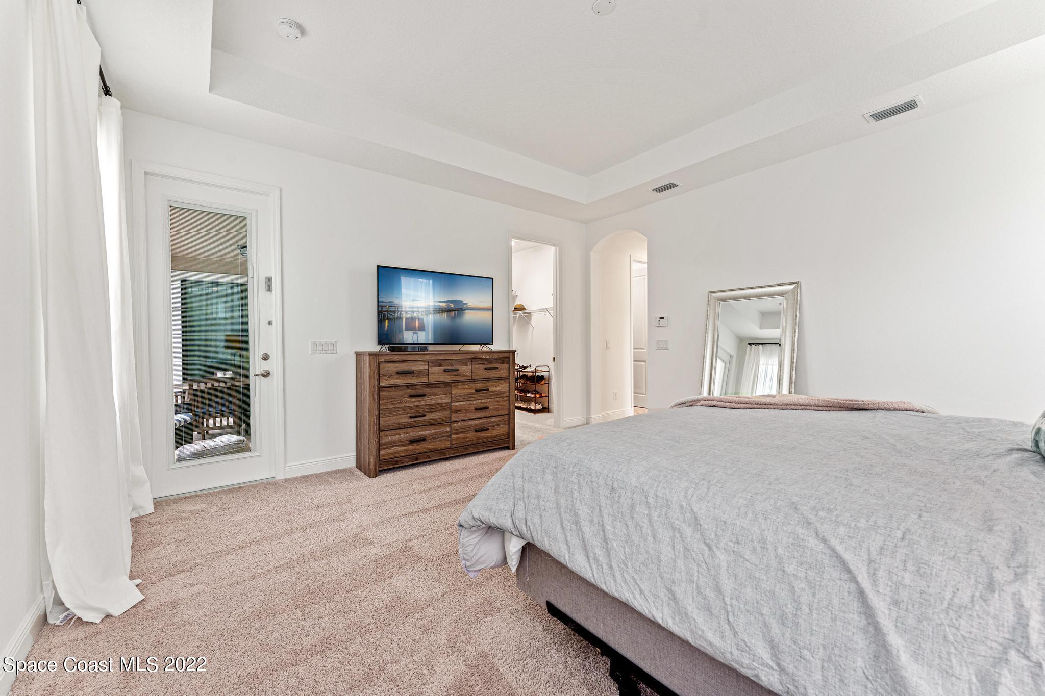 3231 Casterton Drive Melbourne, FL 32940 - Photo 37 of 88 a bedroom with a bed and a television