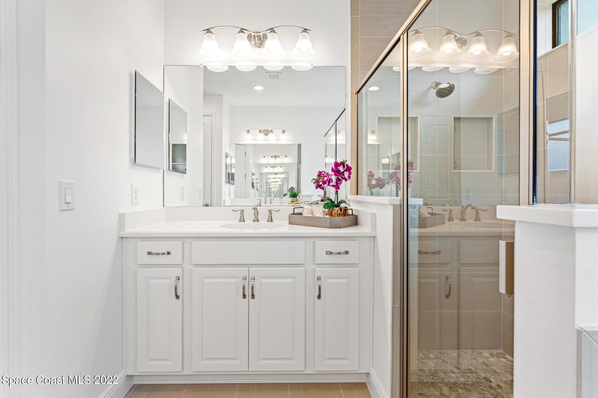 3231 Casterton Drive Melbourne, FL 32940 - Photo 39 of 88 a bathroom with a sink vanity and a mirror