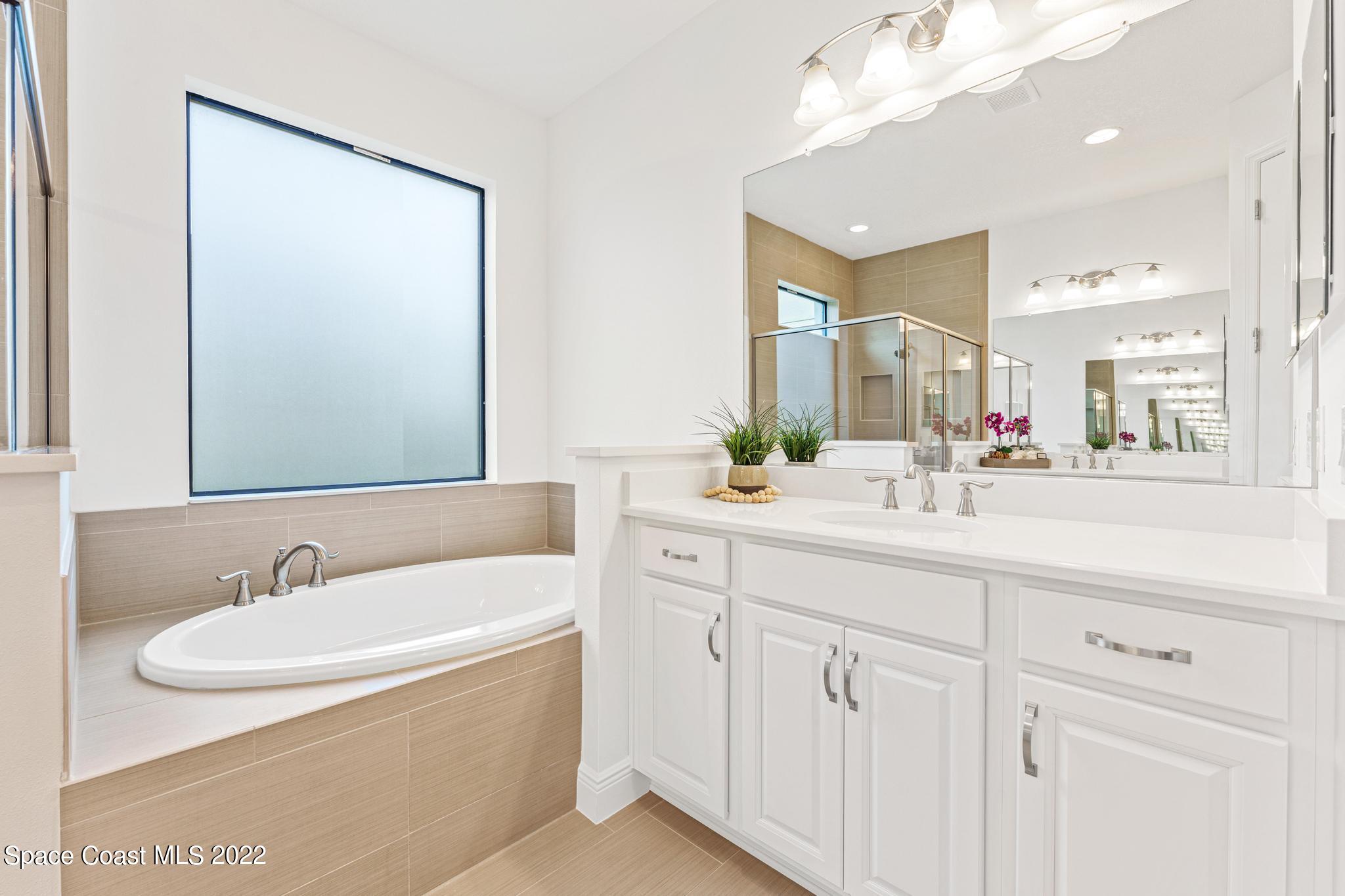 3231 Casterton Drive Melbourne, FL 32940 - Photo 40 of 88 a bathroom with a sink and a mirror