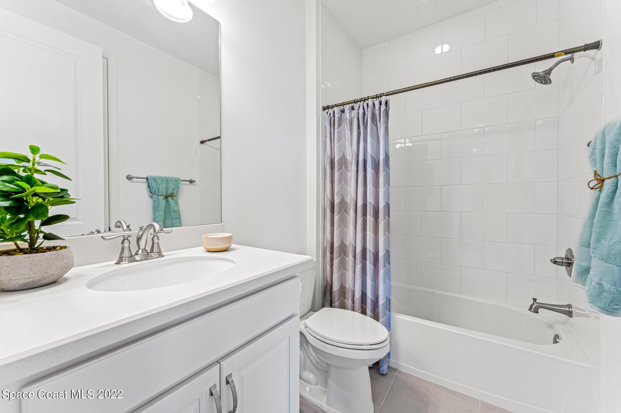 3231 Casterton Drive Melbourne, FL 32940 - Photo 50 of 88 a bathroom with a sink a toilet a mirror and shower