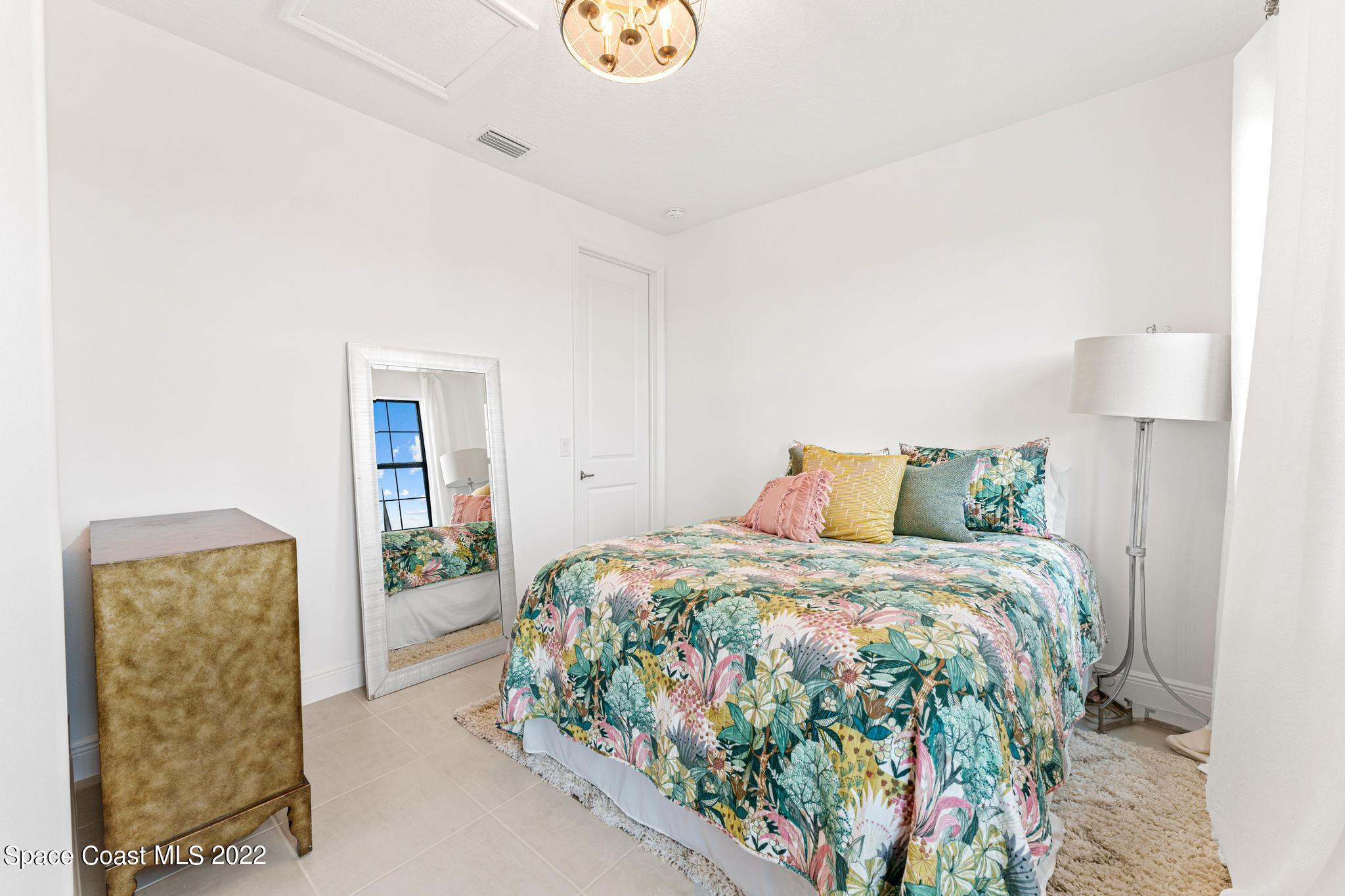 3231 Casterton Drive Melbourne, FL 32940 - Photo 51 of 88 a bedroom with a bed and a window