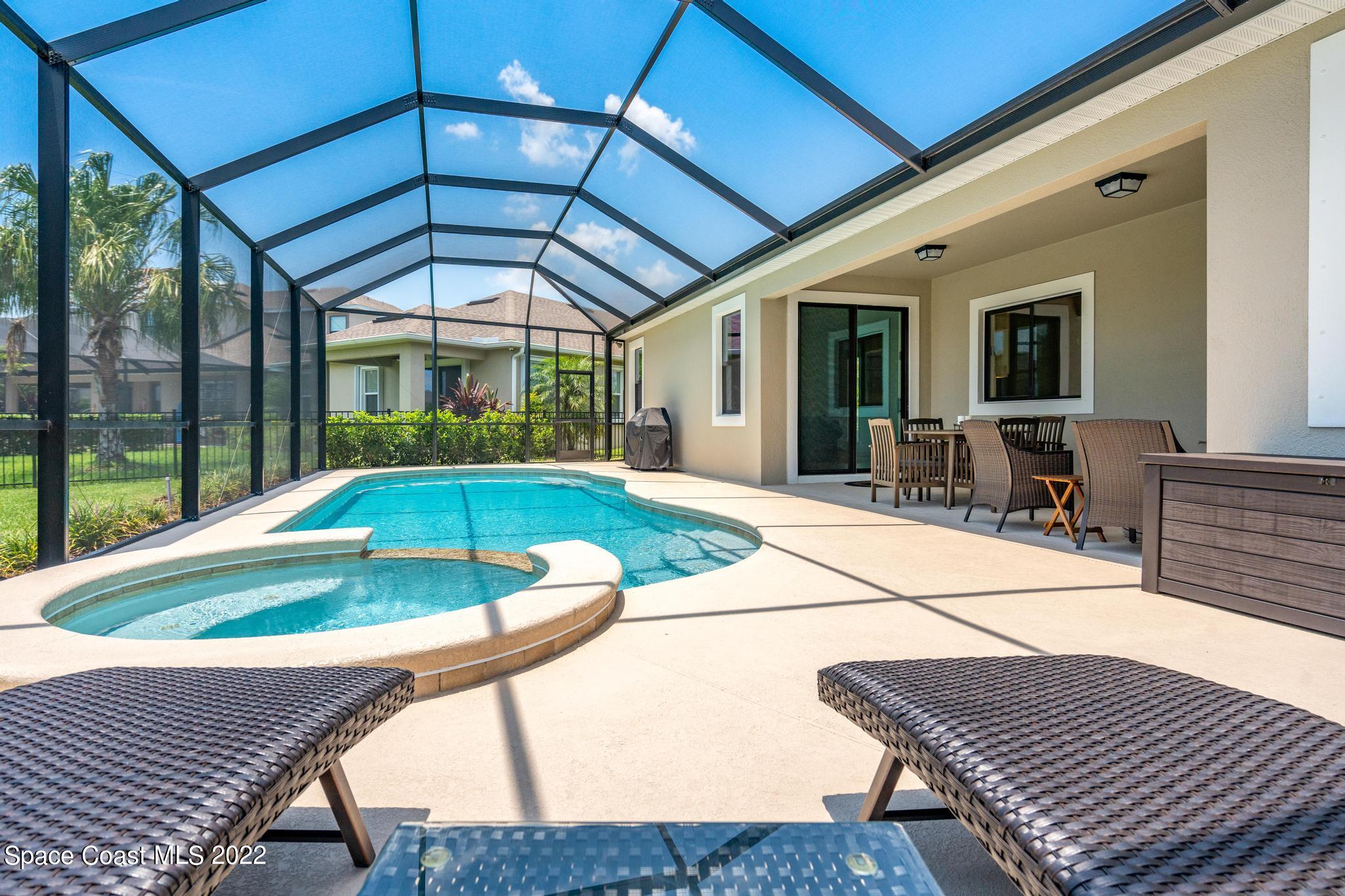 3231 Casterton Drive Melbourne, FL 32940 - Photo 55 of 88 a view of a patio with a table chairs and a barbeque