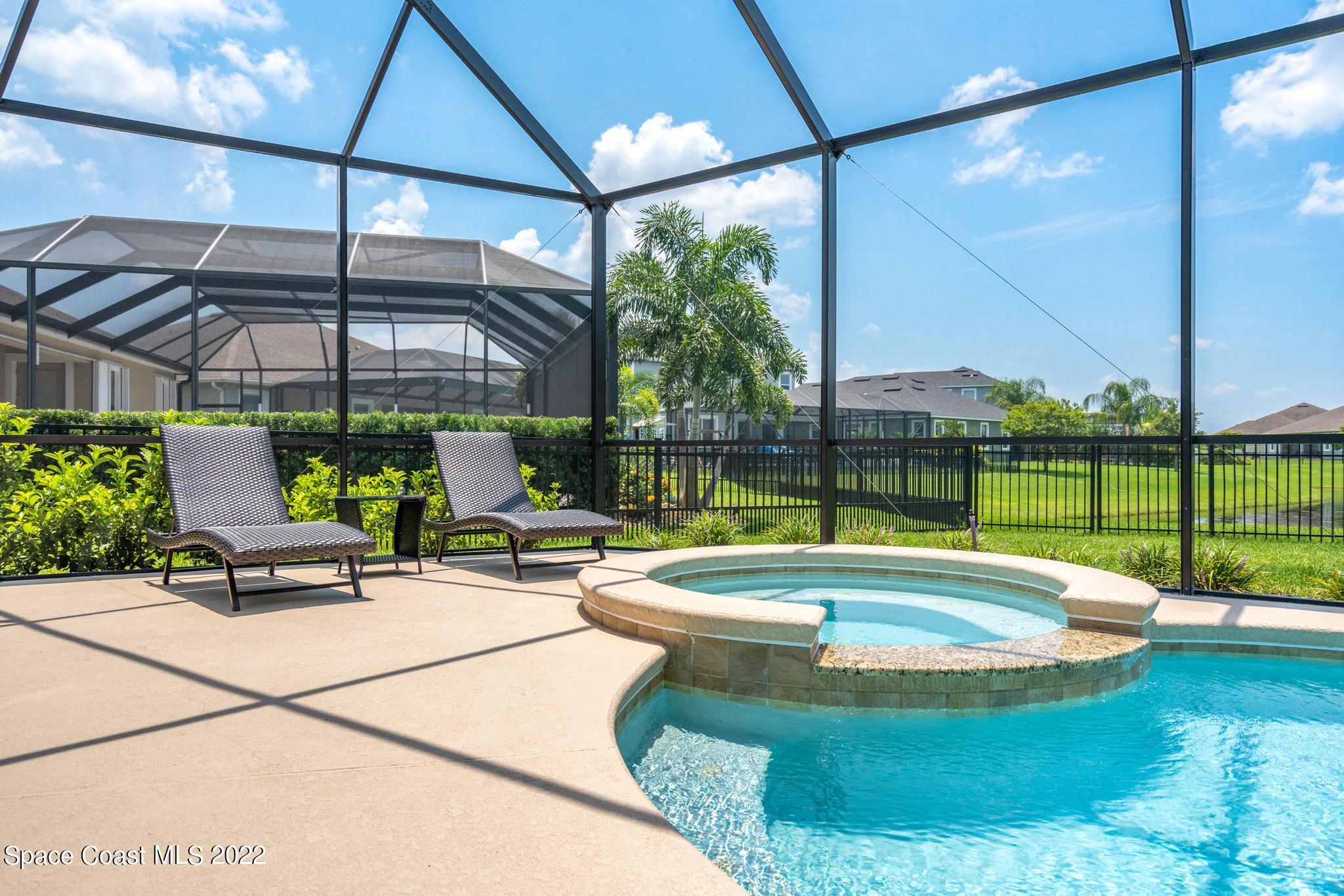 3231 Casterton Drive Melbourne, FL 32940 - Photo 58 of 88 a view of a swimming pool with a patio and a garden