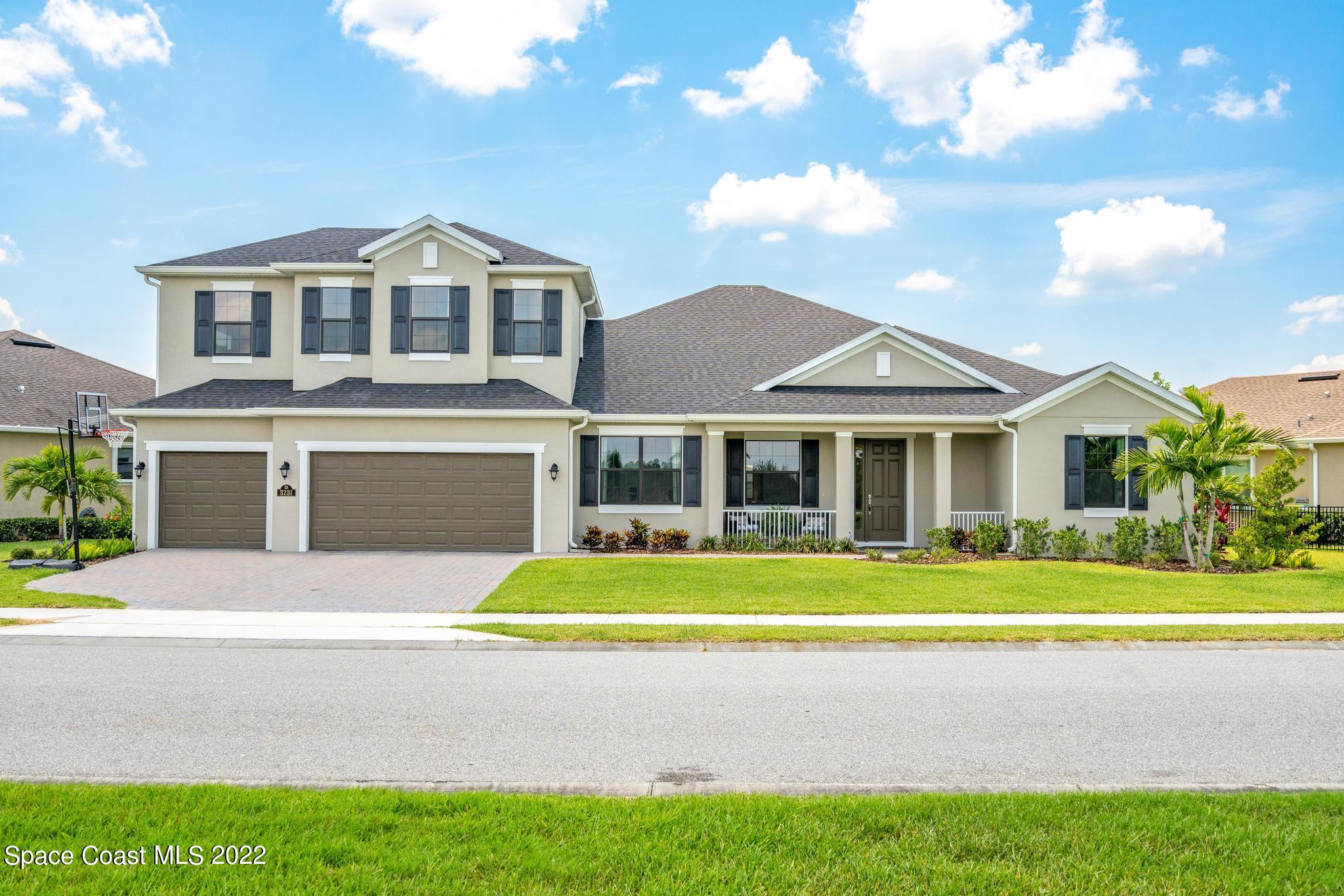 3231 Casterton Drive Melbourne, FL 32940 - Photo 67 of 88 a front view of a house with a garden and porch