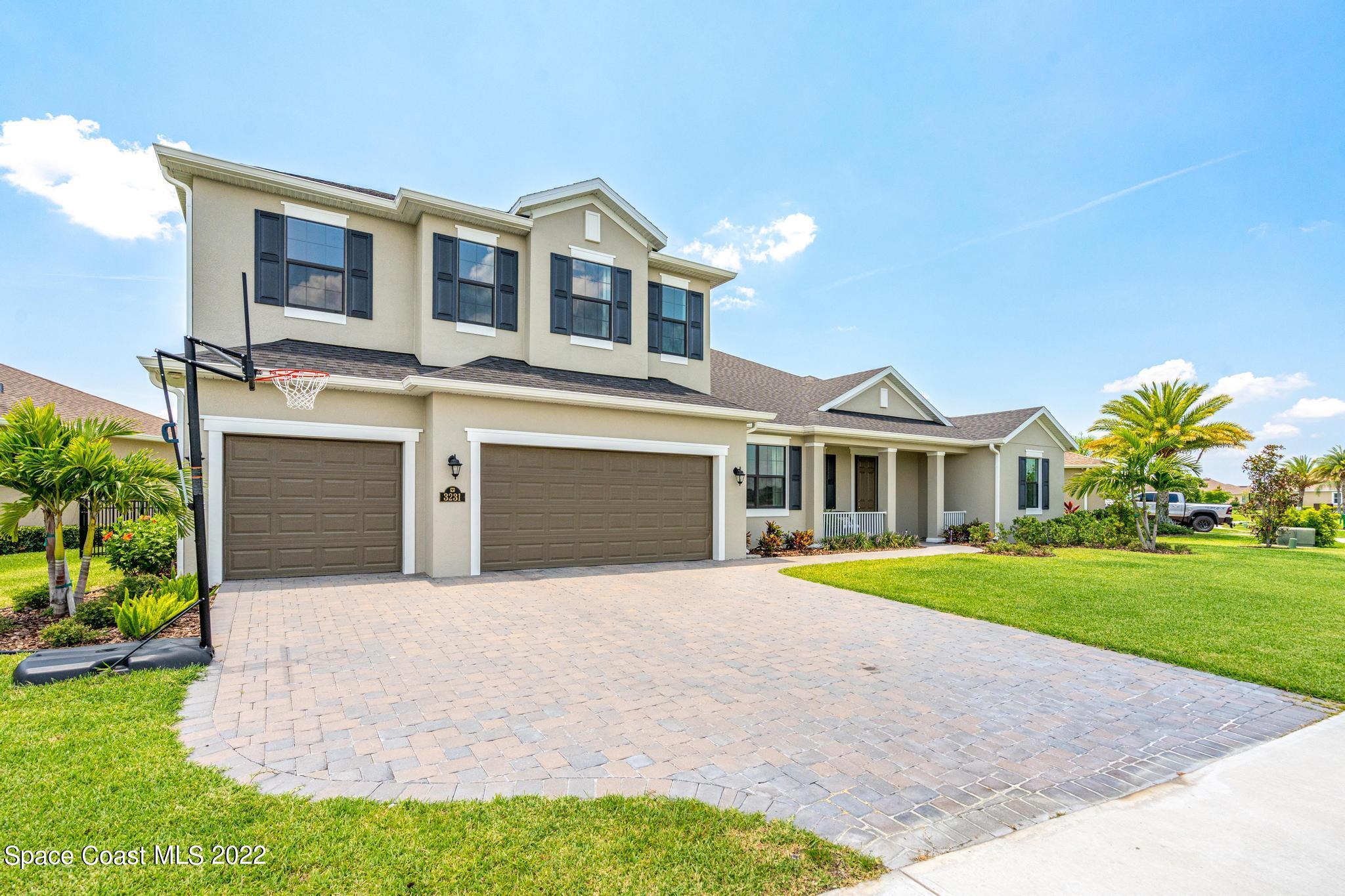 3231 Casterton Drive Melbourne, FL 32940 - Photo 68 of 88 a front view of a house with a yard and garage