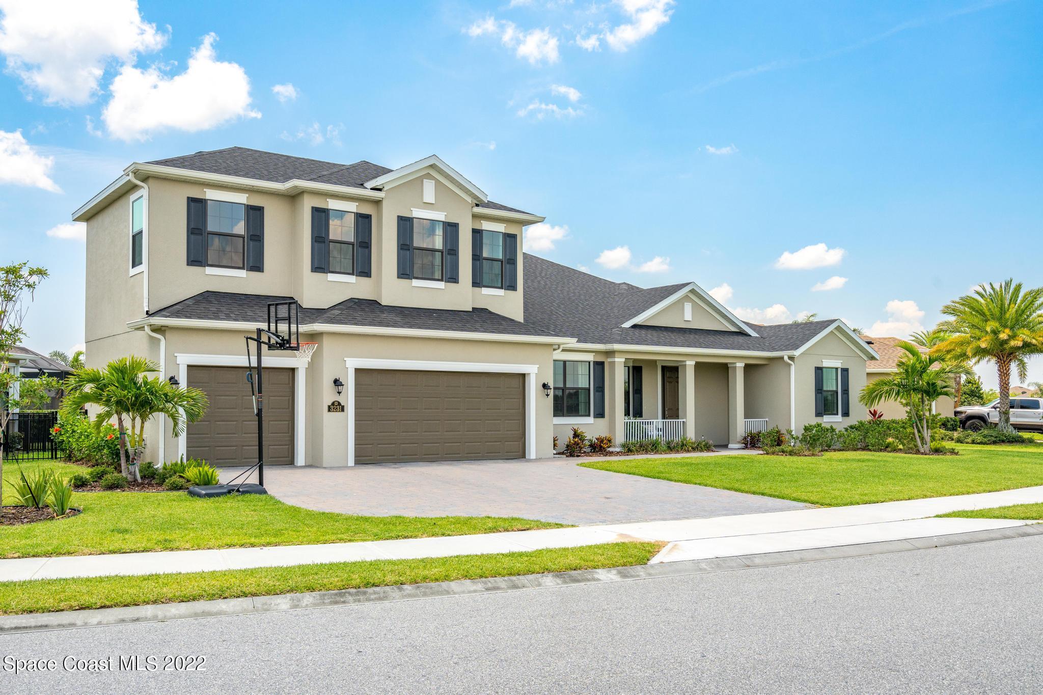 3231 Casterton Drive Melbourne, FL 32940 - Photo 69 of 88 a front view of a house with a garden and yard