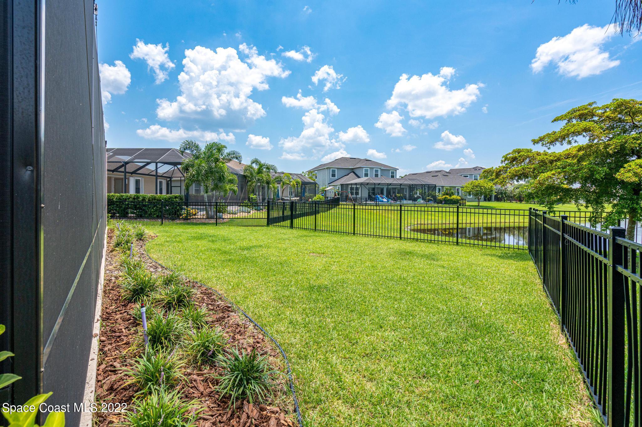 3231 Casterton Drive Melbourne, FL 32940 - Photo 71 of 88 a view of a golf course with a big yard