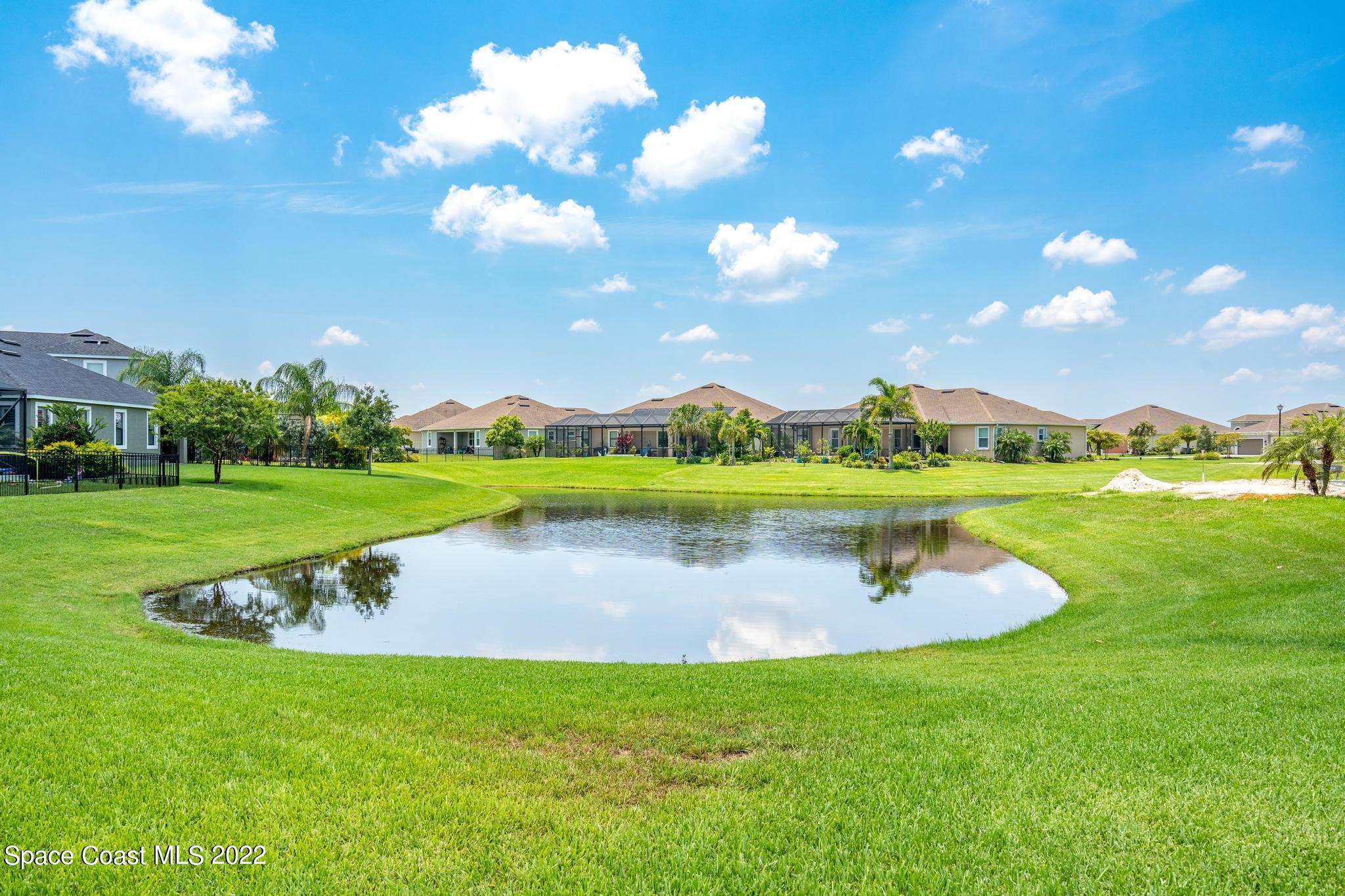 3231 Casterton Drive Melbourne, FL 32940 - Photo 74 of 88 a view of a lake with houses in the back