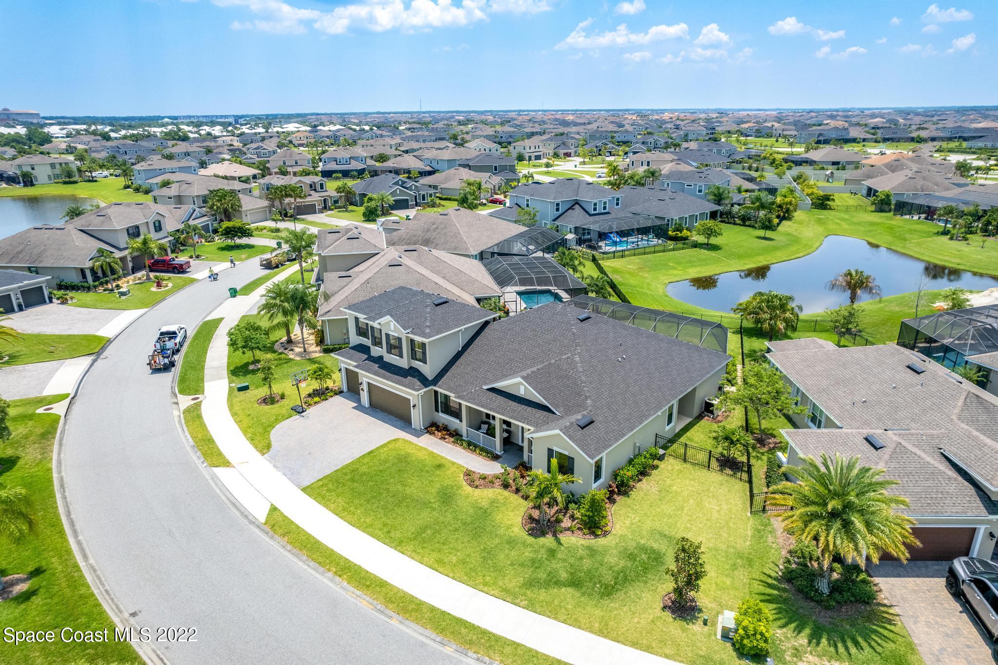 3231 Casterton Drive Melbourne, FL 32940 - Photo 75 of 88 an aerial view of a swimming pool with outdoor seating and yard