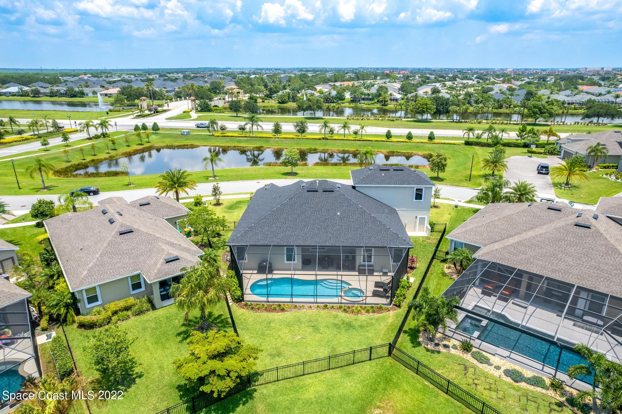 3231 Casterton Drive Melbourne, FL 32940 - Photo 79 of 88 an aerial view of a house with a swimming pool outdoor seating and yard