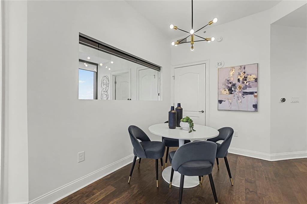 2828 Peachtree Road Northwest, Unit 1704 Atlanta, GA 30305 - Photo 14 of 41 a view of a dining room with furniture and a chandelier fan
